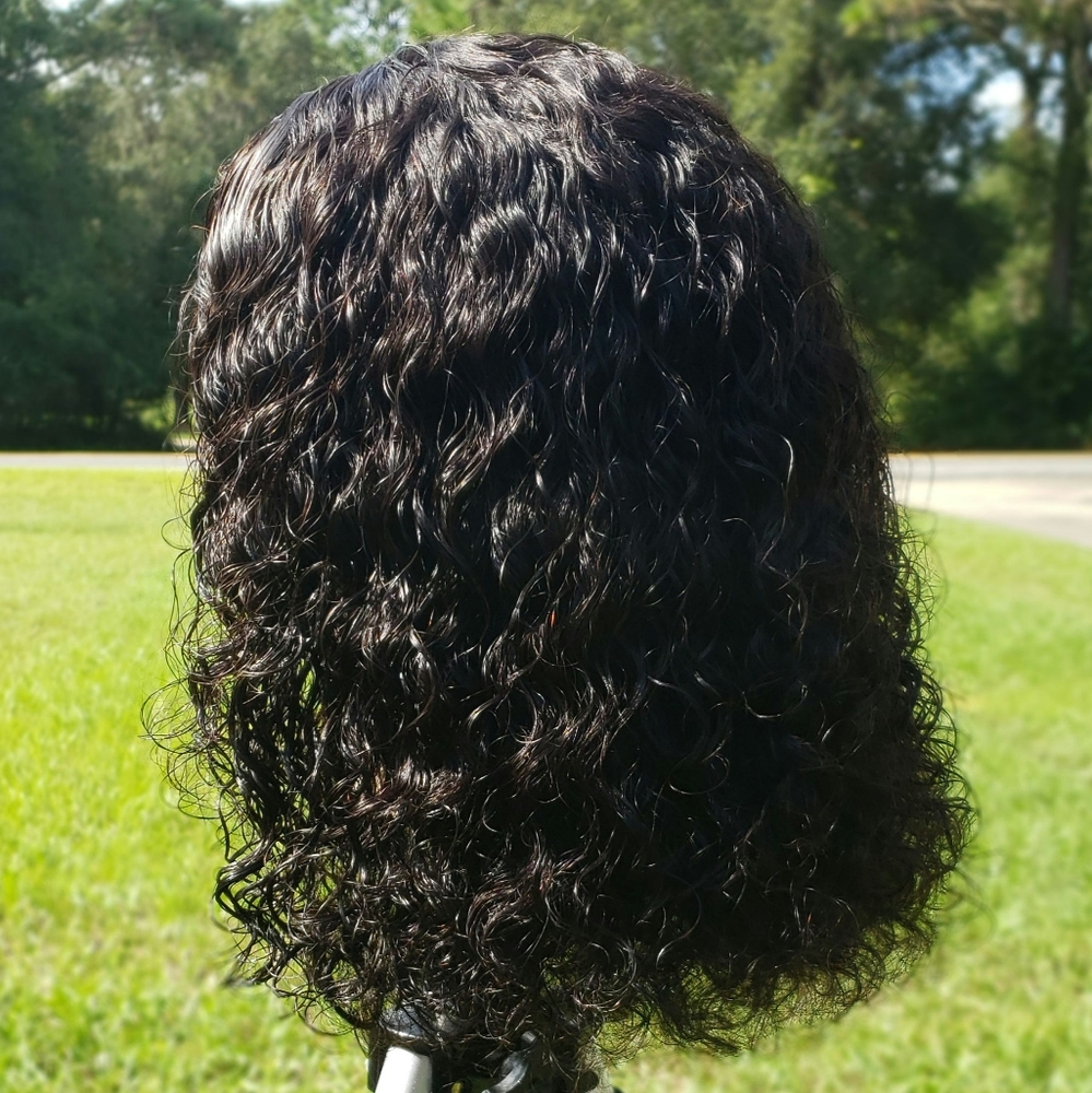 Machine made wefted wig with a small lace closure.